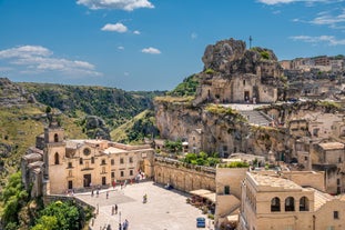 Photo of panoramic view of the ancient town of Matera (Sassi di Matera), European Capital of Culture 2019, in beautiful golden morning light with blue sky and clouds, Basilicata, southern Italy.