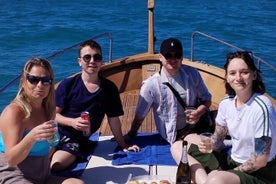 Boat ride from Riomaggiore with stop for swimming and local wine.