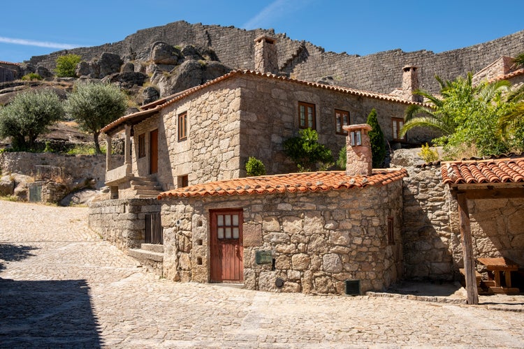 Gothic houses made of stone on deserted alley in Sortelha Castel. Covilha, Castelo Branco, Portugal.