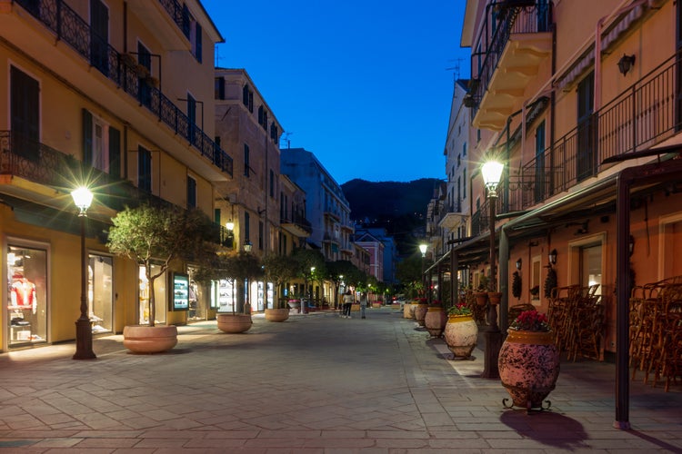 Photo of view along typical Italian narrow street in Alassio old town, Liguria region.