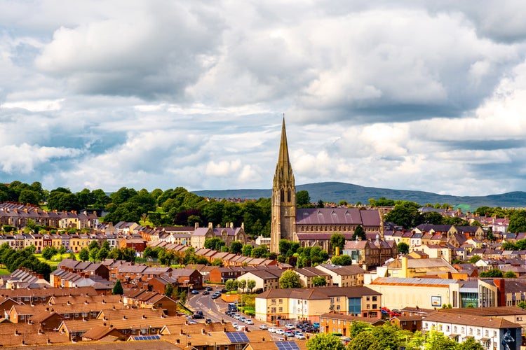 photo of view of Derry, North Ireland. Aerial view of Derry Londonderry city center in Northern Ireland, UK. Sunny day with cloudy sky, city walls and historical buildings.