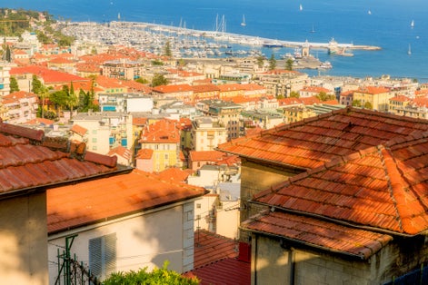 View of Sanremo City, Liguria, Italy showing old town La Pigna and new port. Picture taken from el Santuario Madonna Della Costa on a hill above the city.
