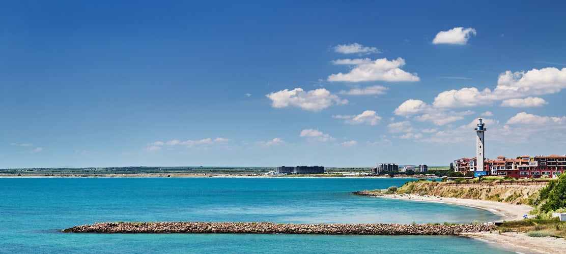 Black Sea coast of Bulgaria with sand beach, lighthouse and blue sky