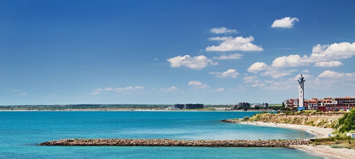 Black Sea coast of Bulgaria with sand beach, lighthouse and blue sky