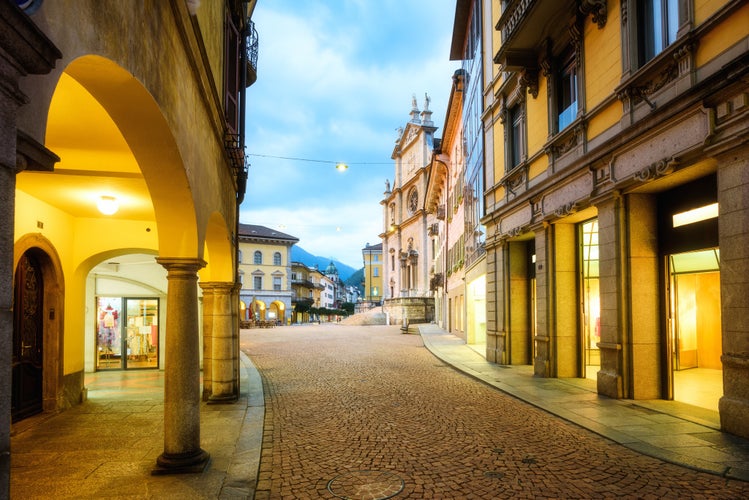 Photo of Central pedestrian street and main square in Bellinzona city's Old town in the evening light, Ticino, Switzerland.