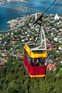 Photo of houses, bridge and panorama of Norwegian city Tromso beyond the Arctic circle from mountain in Norwegian fjords.