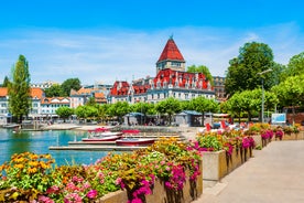 Geneva skyline cityscape, French-Swiss in Switzerland. Aerial view of Jet d'eau fountain, Lake Leman, bay and harbor from the bell tower of Saint-Pierre Cathedral. Sunny day blue sky.