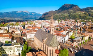 Photo of aerial view of Verona historical city centre, Ponte Pietra bridge across Adige river, Verona Cathedral, Duomo di Verona, red tiled roofs, Veneto Region, Italy.