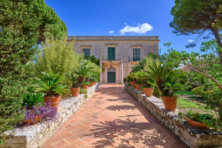 Photo of the facade of an old stone house Modica, Sicily, Italy.