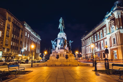 Krakow / Poland - September 5 2018: Jan matejko Square in Krakow, Poland, at night, big monument dedicated to Grunwald battle in 1410 year, street lamps, benches, building on both sides, night skyline