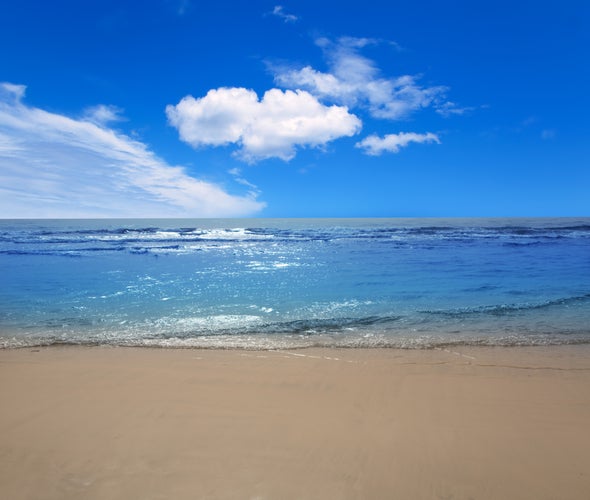 Photo of Maspalomas Playa del Ingles beach sand and blue sky in Gran Canaria, Spain.