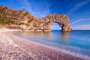 Photo of a stone bridge spans the River Avon, Christchurch, Dorset, England on a hot summer day.