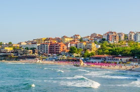 Photo of Saint Anastasia Island in Burgas bay, Black Sea, Bulgaria. Lighthouse tower and old wooden buildings on rocky coast.