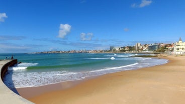 Photo of aerial view over People Crowd Having Fun On Beach And Over Cascais City In Portugal.