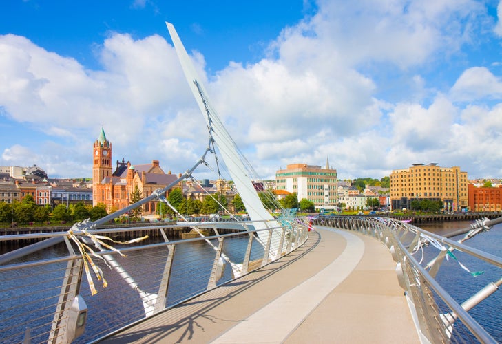 photo of view of Urban skyline of Derry city (also called Londonderry) in northern Ireland with the famous "Peace Bridge" (Europe - Northern Ireland).