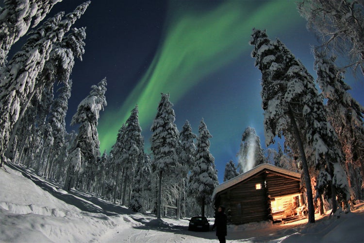 winter landscape in Lapland, snow miracle behind the polar circle in the arctic winter, hidden log cabin under moon light and aurora borealis in the PyhÃ¤-Luosto National Park near of SodankylÃ¤