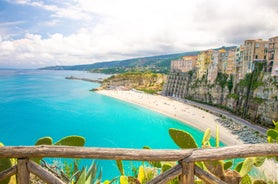 photo of an aerial view of Parghelia in Italy. Overview of seabed seen from above, transparent water and beach with umbrellas.