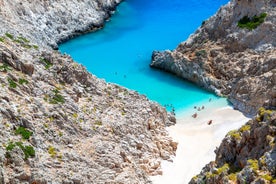 Photo of aerial view of black Perissa beach with beautiful turquoise water, sea waves and straw umbrellas, Greece.