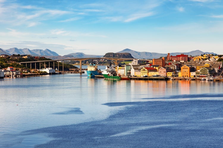 photo of view of Kristiansund cityscape with colorful waterfront buildings and moored ships, More og Romsdal, Norway.