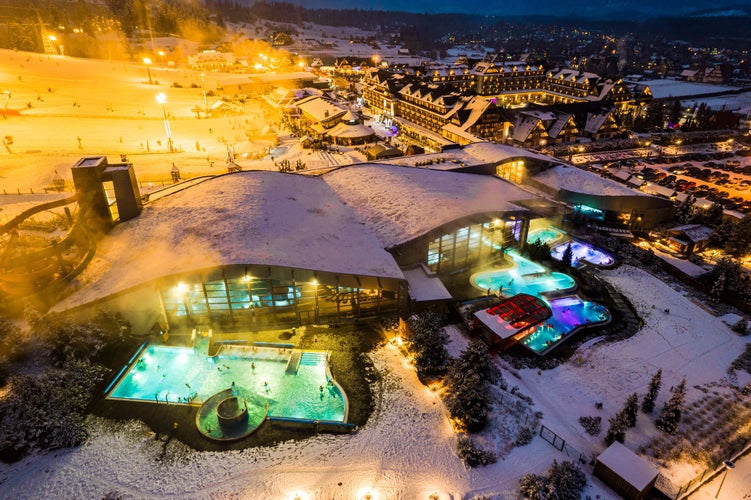 photo of drone view of Bania Thermal Baths at winter night in Zakopane, Poland.