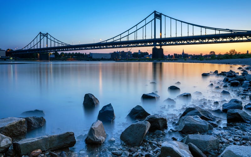 Photo of Old bridge crossing the Rhine river during sunset, Krefeld, North Rhine Westphalia, Germany.