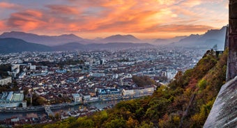 Photo of morning cityscape view with mountains, river and bridge in Grenoble city on the south-east of France.