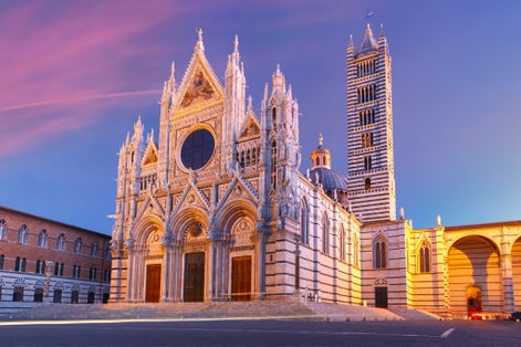 photo of Beautiful view of facade and campanile of Siena Cathedral, Duomo di Siena at sunrise, Siena, Tuscany, Italy .