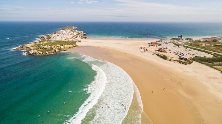 Photo of Praia do Campismo and Island Baleal naer Peniche on the shore of the ocean in west coast of Portugal.