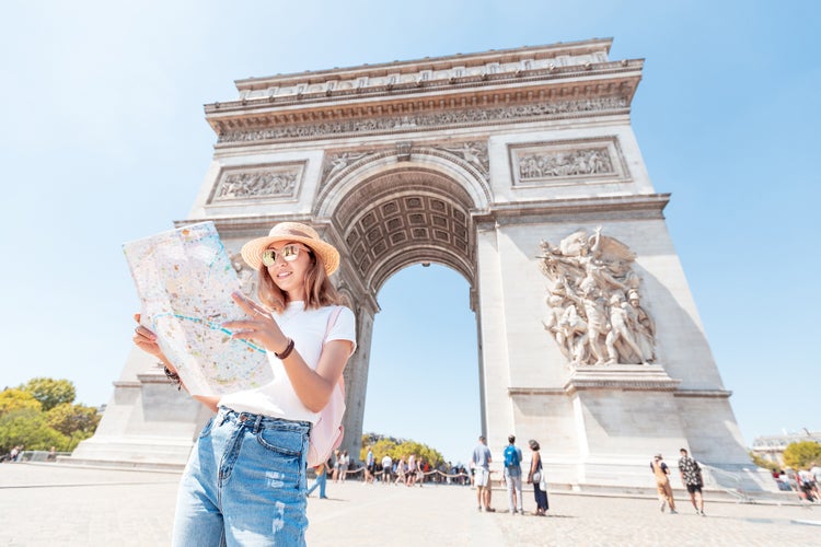 tourist enjoys the view of the majestic and famous Arc de Triomphe or Triumphal arch.jpg