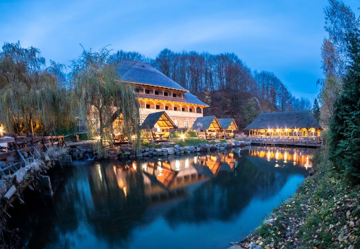 photo of view of Lake and house architecture at night in Sighetu Marmatiei, Maramures - Romania.