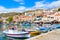 Photo of traditional colourful Greek fishing boats in Pythagorion port, Samos island, Greece.