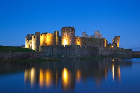 Photo of beautiful view of Caerphilly Castle illuminated at night, Wales, UK.