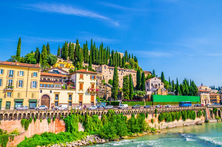 Castel San Pietro St. Peter Castle, Museo Archeologico, Convento di San Girolamo on hill with cypress trees and Adige river in Verona city historical centre, blue sky, Veneto Region, Northern Italy.