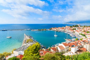 Photo of aerial view of Pythagorio port with colourful houses and blue sea, Samos island, Greece.