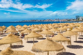 Photo of aerial view over People Crowd Having Fun On Beach And Over Cascais City In Portugal.