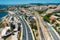 Photo of aerial view of train passing near the Marginal Avenue and coastline with Parade district in Greater Lisbon, Portugal.