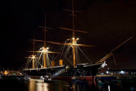 Photo of HMS Victory the Admiral Horatio Nelson's flagship at night at the Battle of Trafalgar in 1805 at Portsmouth Historic Dockyard, UK.
