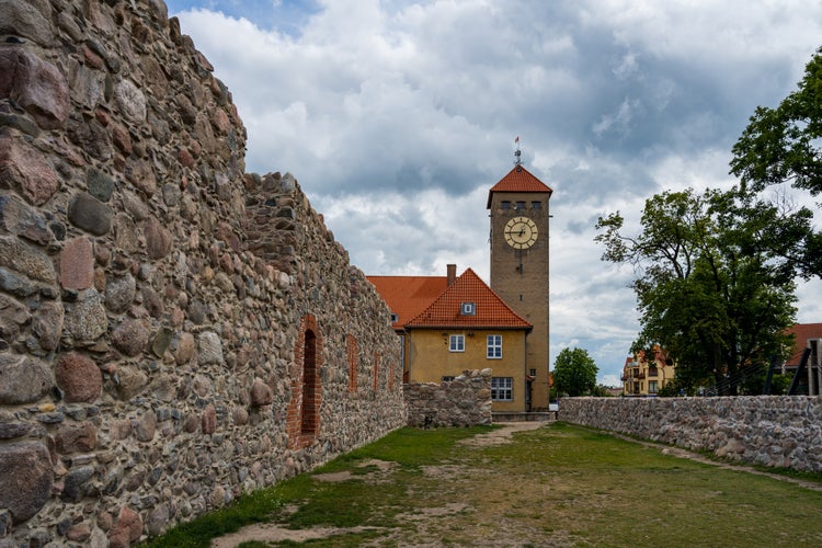 Photo of the clock tower and the ruins of the Teutonic Castle in Szczytno, Poland.