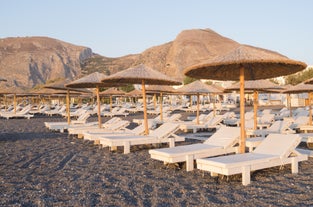 Photo of scenic aerial view of Kamari village and beach at sunrise, Greece.