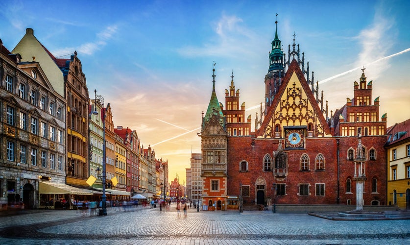 Photo of Wroclaw central market square with old houses and sunset. Panoramic evening view. Historical capital of Silesia, Wroclaw (Breslau) , Poland.