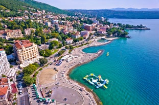 photo of aerial panoramic view of beautiful town of Lovran and sea walkway in Croatia.