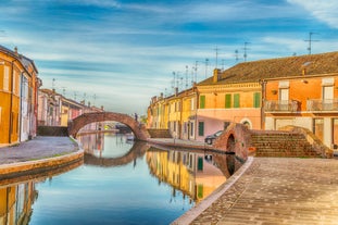 Famous buildings, gondolas and monuments by the Rialto Bridge of Venice on the Grand Canal, Italy.