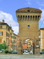 Photo of Italy Piazza Maggiore in Bologna old town tower of town hall with big clock and blue sky on background, antique buildings terracotta galleries.