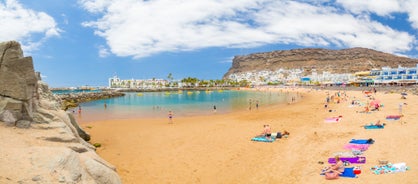 photo of landscape with Maspalomas town and golden sand dunes at sunrise, Gran Canaria, Canary Islands, Spain.