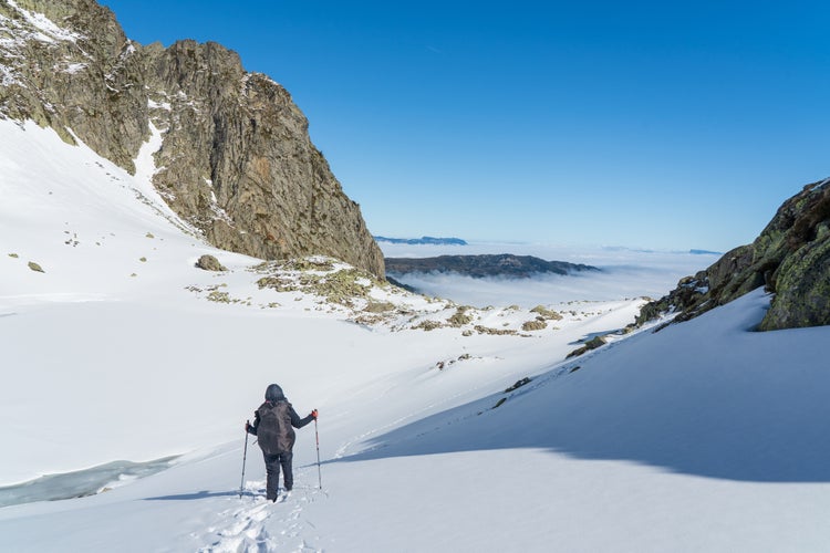 Person walking on the snowy slopes in French Alps near Grenoble