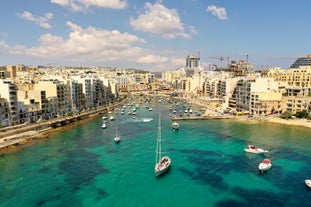 Photo of Msida Marina boat and church reflection into water, Malta.