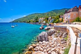 photo of aerial panoramic view of beautiful town of Lovran and sea walkway in Croatia.