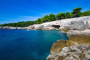 photo of an aerial view of the stunning Croatian coastal town of Pomer, with its picturesque oceanfront buildings and harbor.