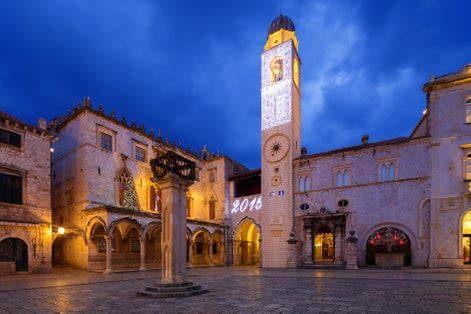 Photo of the Sponza palace at night in Dubrovnik, Croatia.