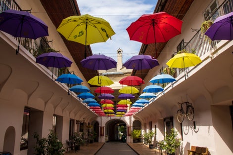 Colourful umbrellas in an alleyway on a sunny day in central Kosice in Slovakia.